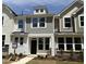 Charming townhome with a black front door, multiple windows, and a combination of lap siding and shake at 6403 Granite Quarry Dr, Raleigh, NC 27610