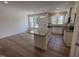 Open-concept kitchen boasts an island with granite countertop and wood-look flooring at 6403 Granite Quarry Dr, Raleigh, NC 27610