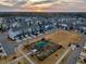 Overhead view of a Primary-planned community, featuring community garden and modern homes at sunset at 6609 Truxton Ln, Raleigh, NC 27616