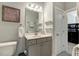 Bright bathroom featuring a vanity with storage and decorative wall art at 6609 Truxton Ln, Raleigh, NC 27616