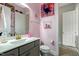 Stylish bathroom with pink walls, modern vanity, and brushed gold fixtures at 6609 Truxton Ln, Raleigh, NC 27616