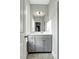 Well-lit bathroom with a modern vanity and ample storage space at 6609 Truxton Ln, Raleigh, NC 27616