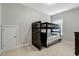 Well-lit bedroom featuring a cozy bunk bed and neutral color palette at 6609 Truxton Ln, Raleigh, NC 27616