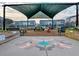 The community garden features a central shaded area with seating and colorful artwork at 6609 Truxton Ln, Raleigh, NC 27616