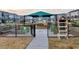 View of the community garden featuring raised beds, a covered seating area, and a sharing station for the neighborhood at 6609 Truxton Ln, Raleigh, NC 27616