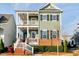 Charming two-story home with inviting double porches, brick accents, and well-maintained landscaping at 6609 Truxton Ln, Raleigh, NC 27616