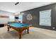 The game room boasts a pool table, foosball, natural light and plenty of space to relax and have fun at 6609 Truxton Ln, Raleigh, NC 27616