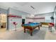 Finished basement game room featuring a pool table, foosball, and unique painted walls at 6609 Truxton Ln, Raleigh, NC 27616