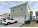 Exterior view of a well-maintained home with a two-car garage and ample parking at 6609 Truxton Ln, Raleigh, NC 27616