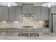 Stylish kitchen with marble backsplash, gray cabinets and granite countertops at 6609 Truxton Ln, Raleigh, NC 27616
