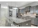Modern kitchen with a large island, stainless steel appliances, and gray cabinets at 6609 Truxton Ln, Raleigh, NC 27616