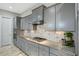 Spacious kitchen featuring modern gray cabinets, stainless appliances and gas range at 6609 Truxton Ln, Raleigh, NC 27616