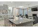 Open concept kitchen with island and view of living room fireplace at 6609 Truxton Ln, Raleigh, NC 27616