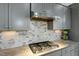 Modern kitchen features gray cabinets, marble countertops, and stainless steel appliances at 6609 Truxton Ln, Raleigh, NC 27616