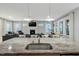 Open concept kitchen with island sink, flowing into the living room and a cozy fireplace at 6609 Truxton Ln, Raleigh, NC 27616