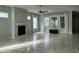 Bright living room featuring a fireplace, large windows, and neutral decor at 6609 Truxton Ln, Raleigh, NC 27616