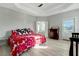 Bright main bedroom features tray ceiling, cheerful bedding, and ensuite bathroom access at 6609 Truxton Ln, Raleigh, NC 27616