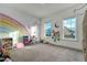Bright playroom with large rainbow mural, filled with toys and natural light at 6609 Truxton Ln, Raleigh, NC 27616