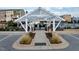 A view of the entrance to the community pool under a pergola at 6609 Truxton Ln, Raleigh, NC 27616