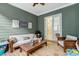 Inviting porch with seating area and sliding glass doors for easy indoor/outdoor living at 6609 Truxton Ln, Raleigh, NC 27616