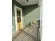 Inviting porch with wood floors, a yellow door, and comfortable seating at 6609 Truxton Ln, Raleigh, NC 27616