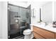 Modern bathroom with wood vanity, stylish faucet, and glass-enclosed shower with tiled walls at 721 Jones Ferry Rd, Chapel Hill, NC 27516