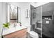 Modern bathroom with wood vanity, stylish faucet, and glass-enclosed shower with tiled walls at 721 Jones Ferry Rd, Chapel Hill, NC 27516