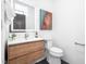 Modern bathroom featuring a wood vanity, illuminated mirror and sleek fixtures at 721 Jones Ferry Rd, Chapel Hill, NC 27516