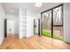 Spacious bedroom featuring hardwood floors, an exterior entrance and a large window with nature views at 721 Jones Ferry Rd, Chapel Hill, NC 27516