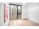 Bright bedroom with hardwood floors, a modern ceiling fan, and a large window offering natural light at 721 Jones Ferry Rd, Chapel Hill, NC 27516