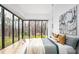 Serene bedroom with expansive windows, hardwood floors, and a view of the surrounding greenery at 721 Jones Ferry Rd, Chapel Hill, NC 27516