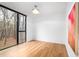 Serene bedroom with hardwood floors, a modern ceiling fan, and a large window offering natural light at 721 Jones Ferry Rd, Chapel Hill, NC 27516