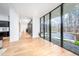 Bright hallway with floor to ceiling windows and tile flooring at 721 Jones Ferry Rd, Chapel Hill, NC 27516
