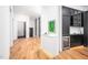 Stylish hallway with wood floors, contemporary cabinets, and a built-in wine cooler for added convenience at 721 Jones Ferry Rd, Chapel Hill, NC 27516