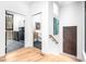 Hallway with a view of the laundry room, bathroom, artwork on the wall and staircase at 721 Jones Ferry Rd, Chapel Hill, NC 27516