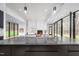 Modern kitchen with marble countertop island, stainless steel appliances, and open living area at 721 Jones Ferry Rd, Chapel Hill, NC 27516