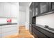 Modern black and white kitchen with sleek cabinets, granite countertops, and stainless steel wine cooler at 721 Jones Ferry Rd, Chapel Hill, NC 27516