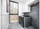 The laundry room features modern appliances, tile flooring and a large window offering natural light at 721 Jones Ferry Rd, Chapel Hill, NC 27516