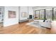 Cozy living room with a fireplace, modern furniture, and large windows with wood views at 721 Jones Ferry Rd, Chapel Hill, NC 27516
