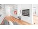 Elegant living room with hardwood floors, built-in shelving, and a modern fireplace feature wall at 721 Jones Ferry Rd, Chapel Hill, NC 27516