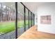 Bright living room with floor-to-ceiling windows, hardwood floors, and natural light at 721 Jones Ferry Rd, Chapel Hill, NC 27516