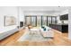 Bright living room with hardwood floors, modern fireplace, and expansive windows at 721 Jones Ferry Rd, Chapel Hill, NC 27516