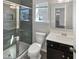 Modern bathroom with tiled shower, sleek vanity, and large mirror, offering a stylish space at 7331 Livestock Rd, Mebane, NC 27302