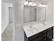 Bathroom with double sink vanity, quartz countertop, and large mirror with modern lighting at 7331 Livestock Rd, Mebane, NC 27302