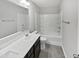 Bathroom with a double sink vanity, tile floors, and a shower-tub combo with white tiling at 7331 Livestock Rd, Mebane, NC 27302
