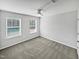 Neutral bedroom with grey carpet, ceiling fan, and a double window for natural light at 7331 Livestock Rd, Mebane, NC 27302