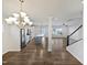 Open-concept living area with hardwood floors, modern kitchen with stainless steel appliances, and adjacent dining space at 7331 Livestock Rd, Mebane, NC 27302