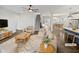 Bright, staged living room with modern decor, open layout to kitchen and dining, and beautiful hardwood floors at 7331 Livestock Rd, Mebane, NC 27302