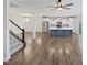 Open living space with hardwood floors, staircase, and kitchen with an island and stainless appliances at 7331 Livestock Rd, Mebane, NC 27302