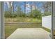 An enclosed backyard featuring a patio and view of trees, creating a private outdoor area at 818 Houston Ct, Haw River, NC 27258